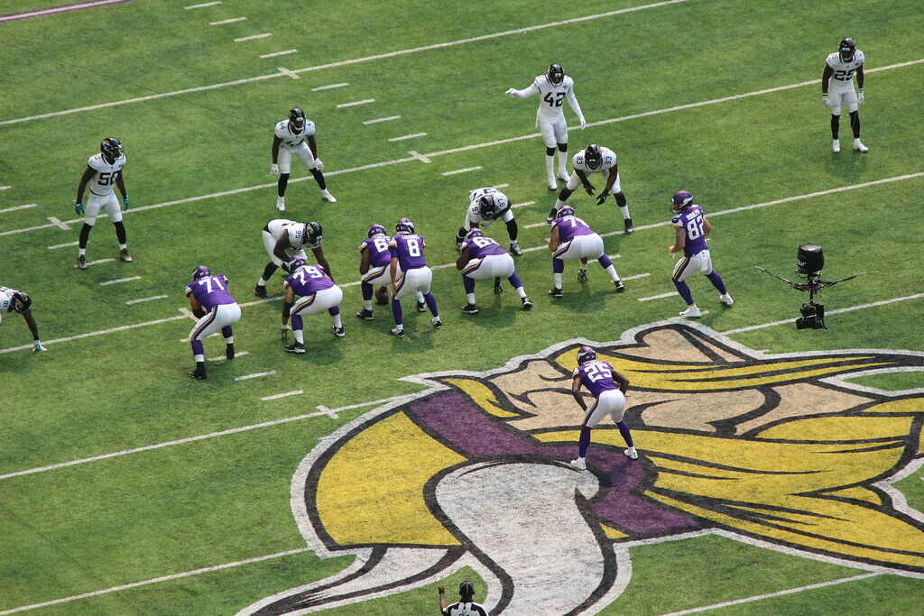 Campo do time da NFL Minnesota Vikings com jogadores perfilados para uma jogada ofensiva