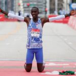 (FILES) Kenya's Kelvin Kiptum celebrates winning the 2023 Bank of America Chicago Marathon in Chicago, Illinois, in a world record time of two hours and 35 seconds on October 8, 2023. - World marathon record holder Kelvin Kiptum and his coach Gervais Hakizimana have died in a car crash in western Kenya that left a third passenger also injured, police said on February 11, 2024.