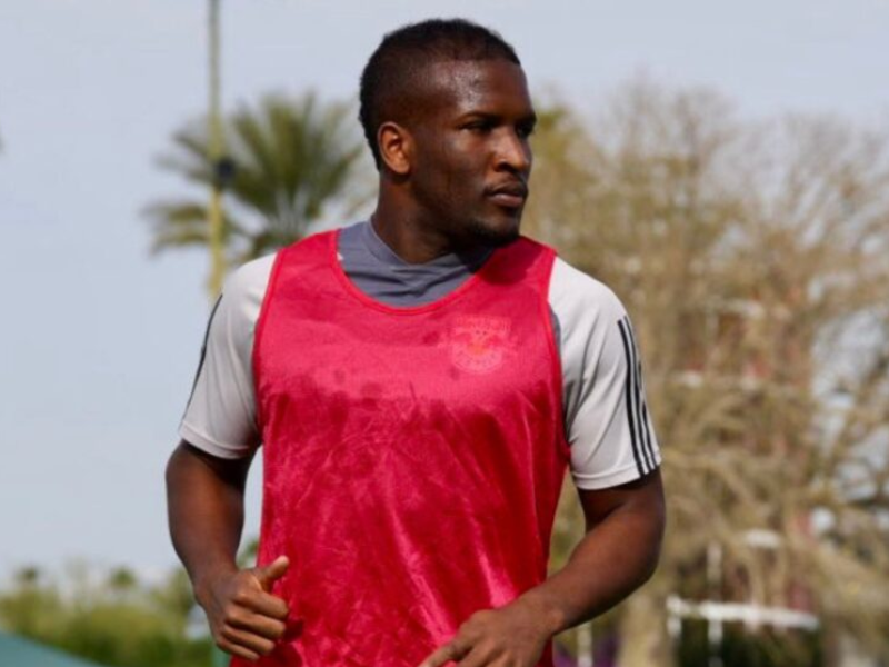 Elias Manoel sorrindo com a camisa do Real Salt Lake no estádio.