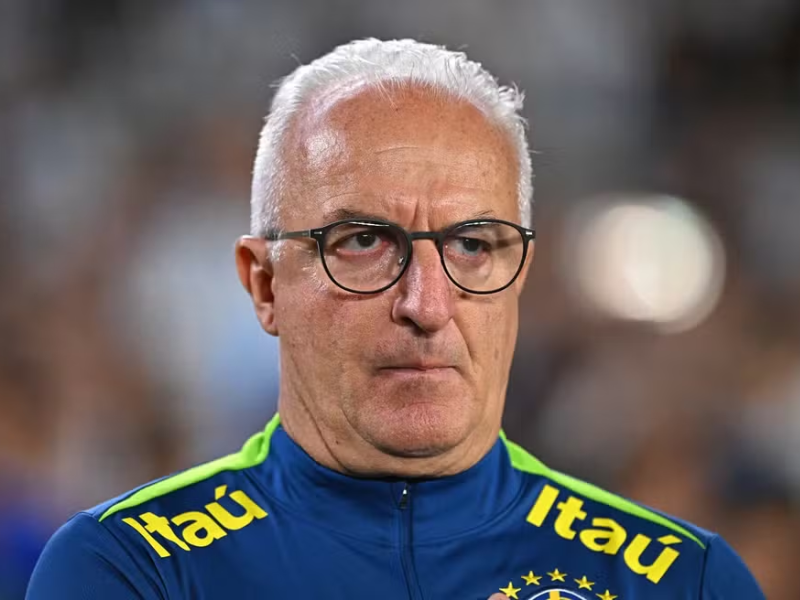 Dorival Júnior gesticulando durante treino da seleção brasileira em estádio lotado.