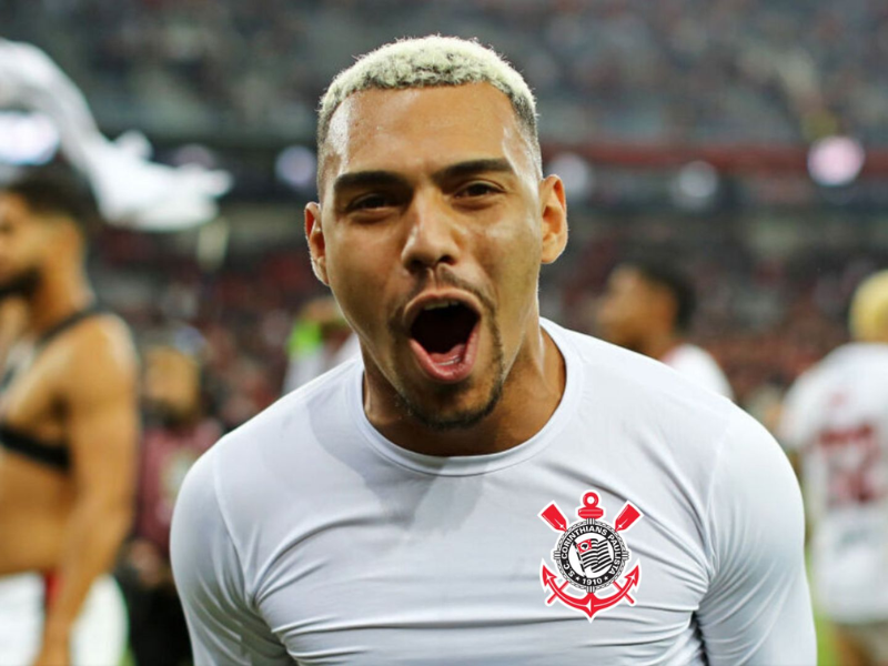 Um jogador do Corinthians, de costas, chuta uma bola de futebol em um campo iluminado, celebrando um gol crucial.